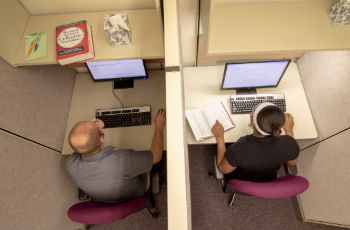 Two students taking the knowledge exam on computers